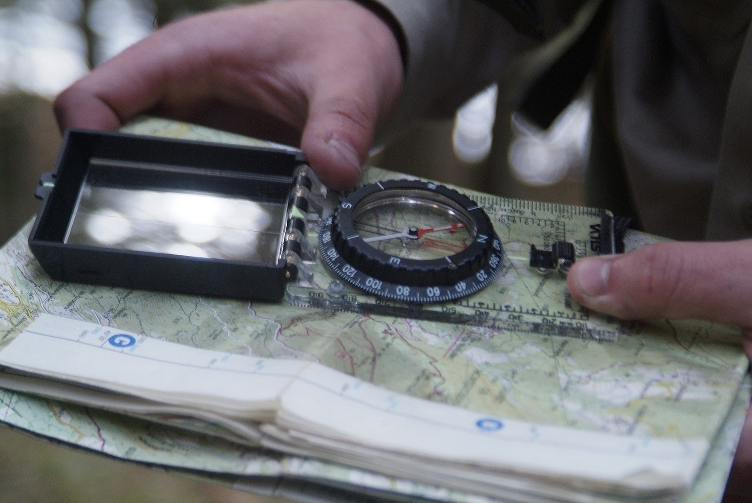 A baseplate compass shown on a topographic map.