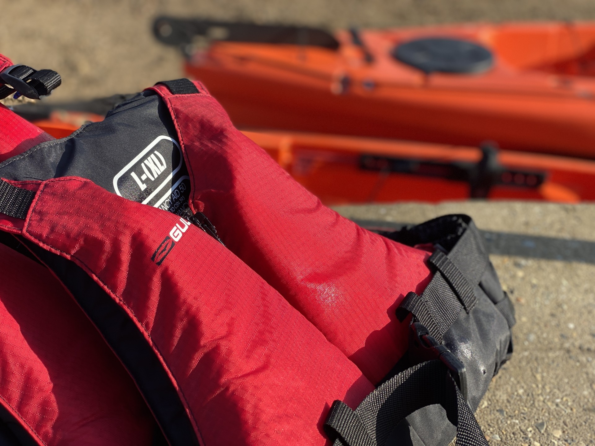 Red buoyancy aids with NOMAD Sea Kayaking.