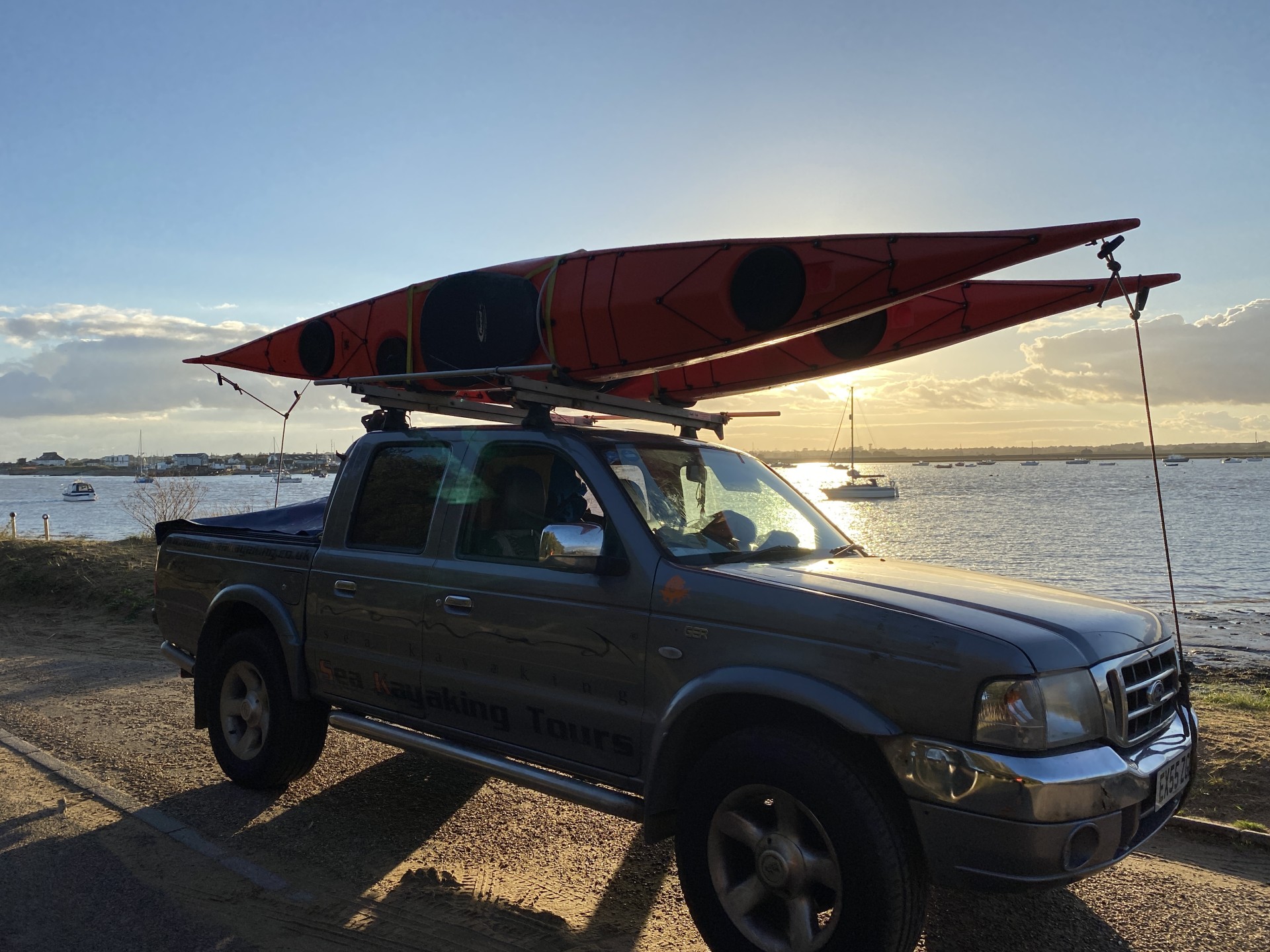 Sea kayaks on the roofrack with NOMAD Sea Kayaking.