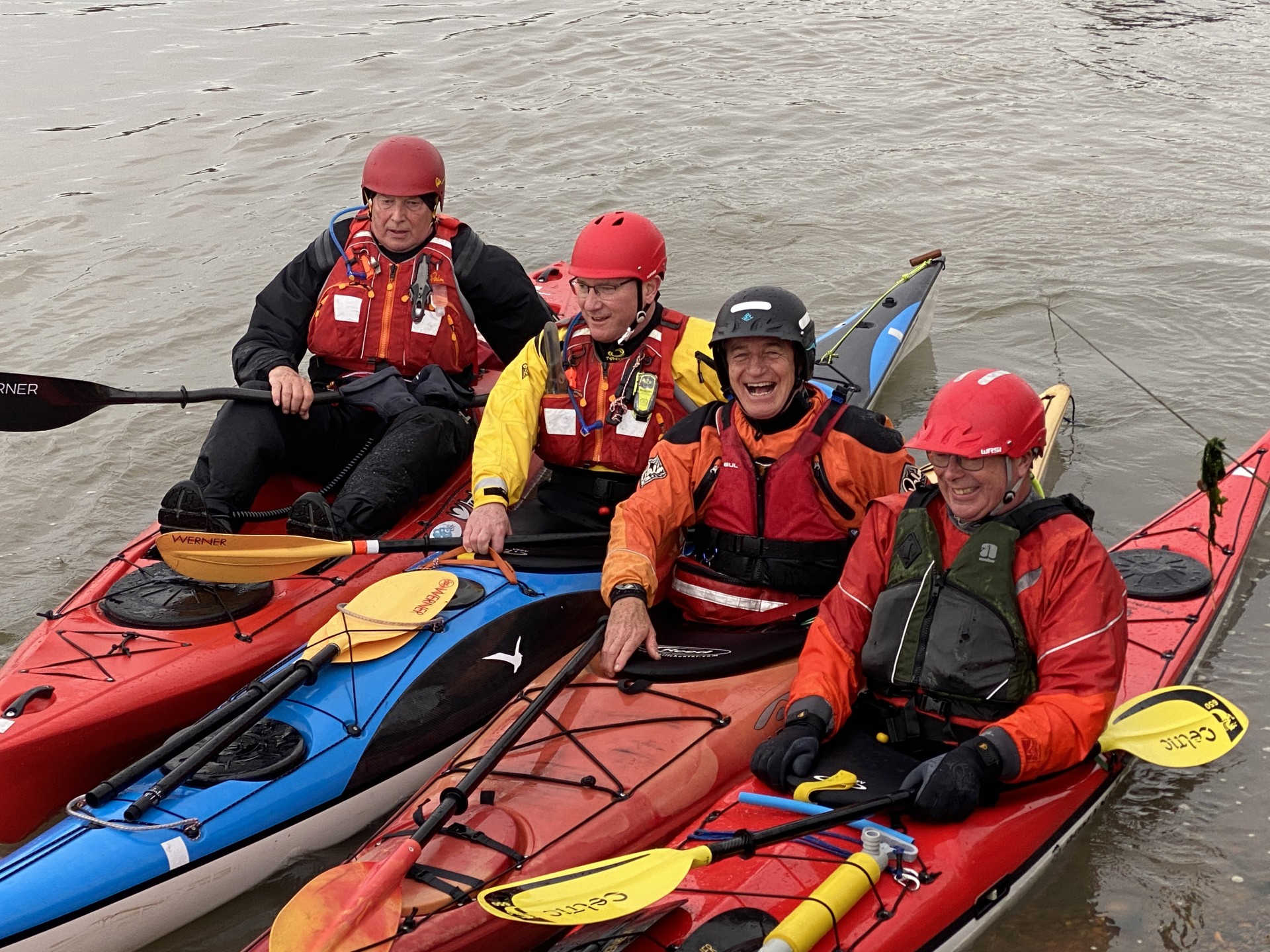 Sea kayakers with helmets.