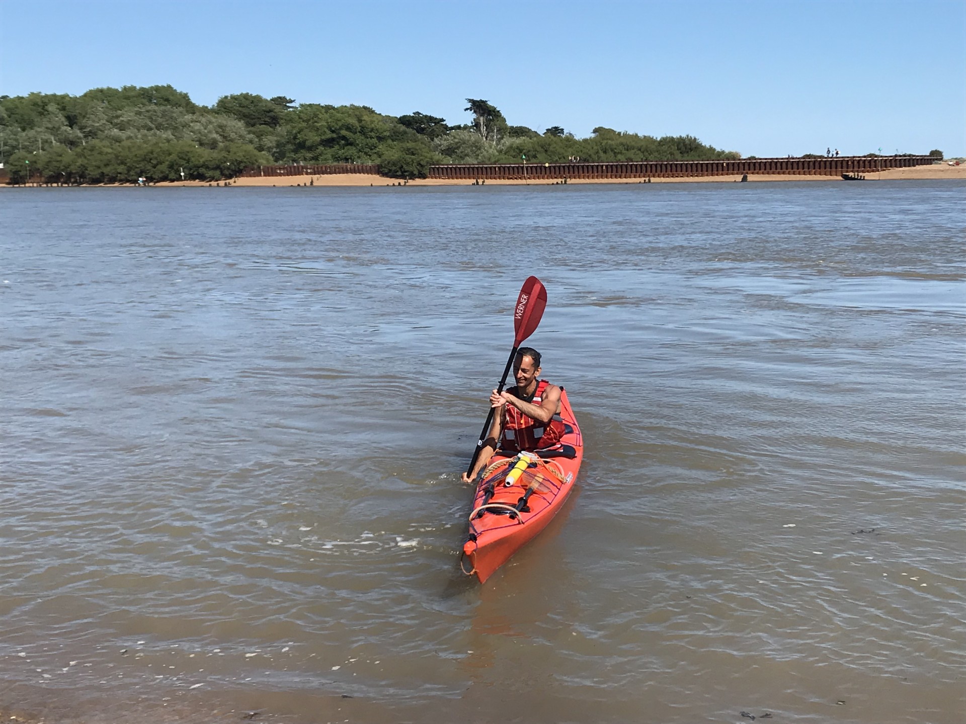 Sea kayaker ready to depart with NOMAD Sea Kayaking.