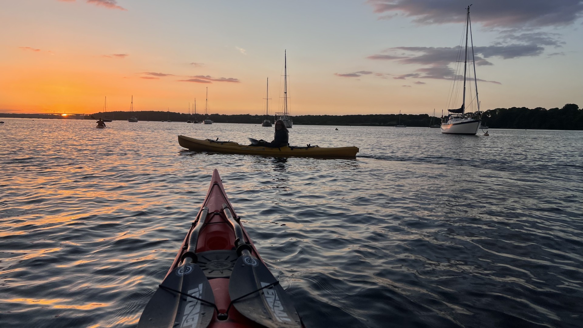 Sunset paddling with NOMAD Sea Kayaking.