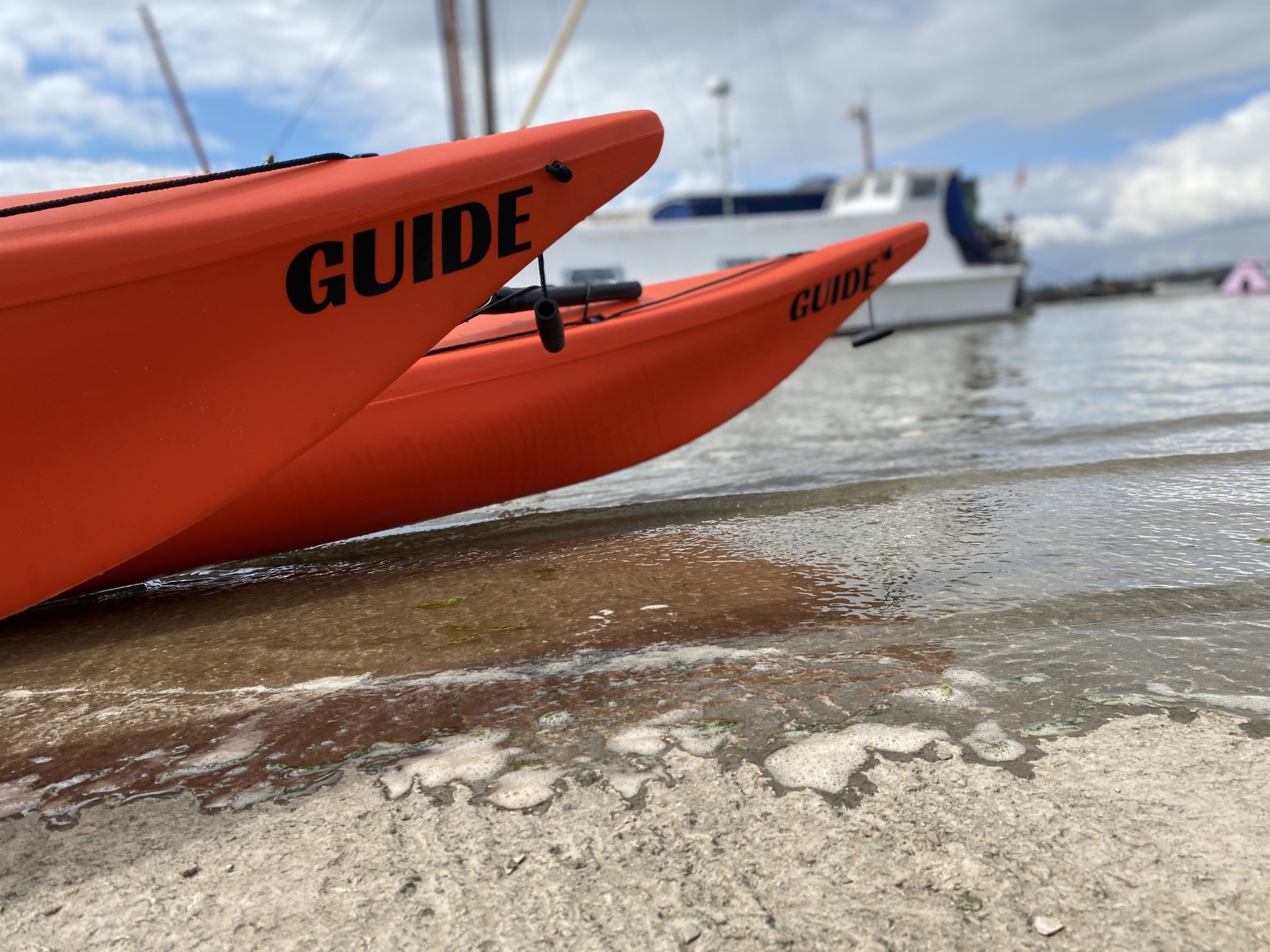 Guide kayaks on a slipway on the Orwell estuary.