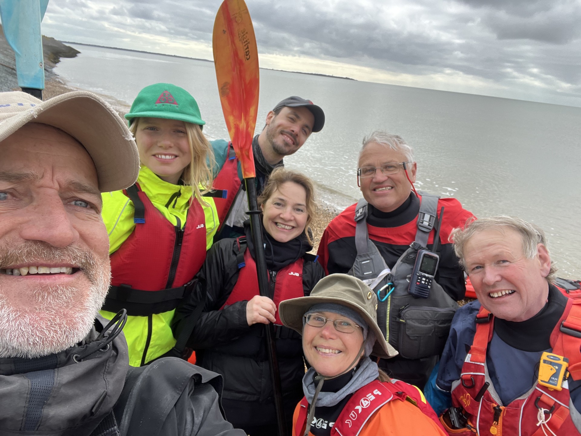 Smiling kayakers with NOMAD Sea Kayaking.