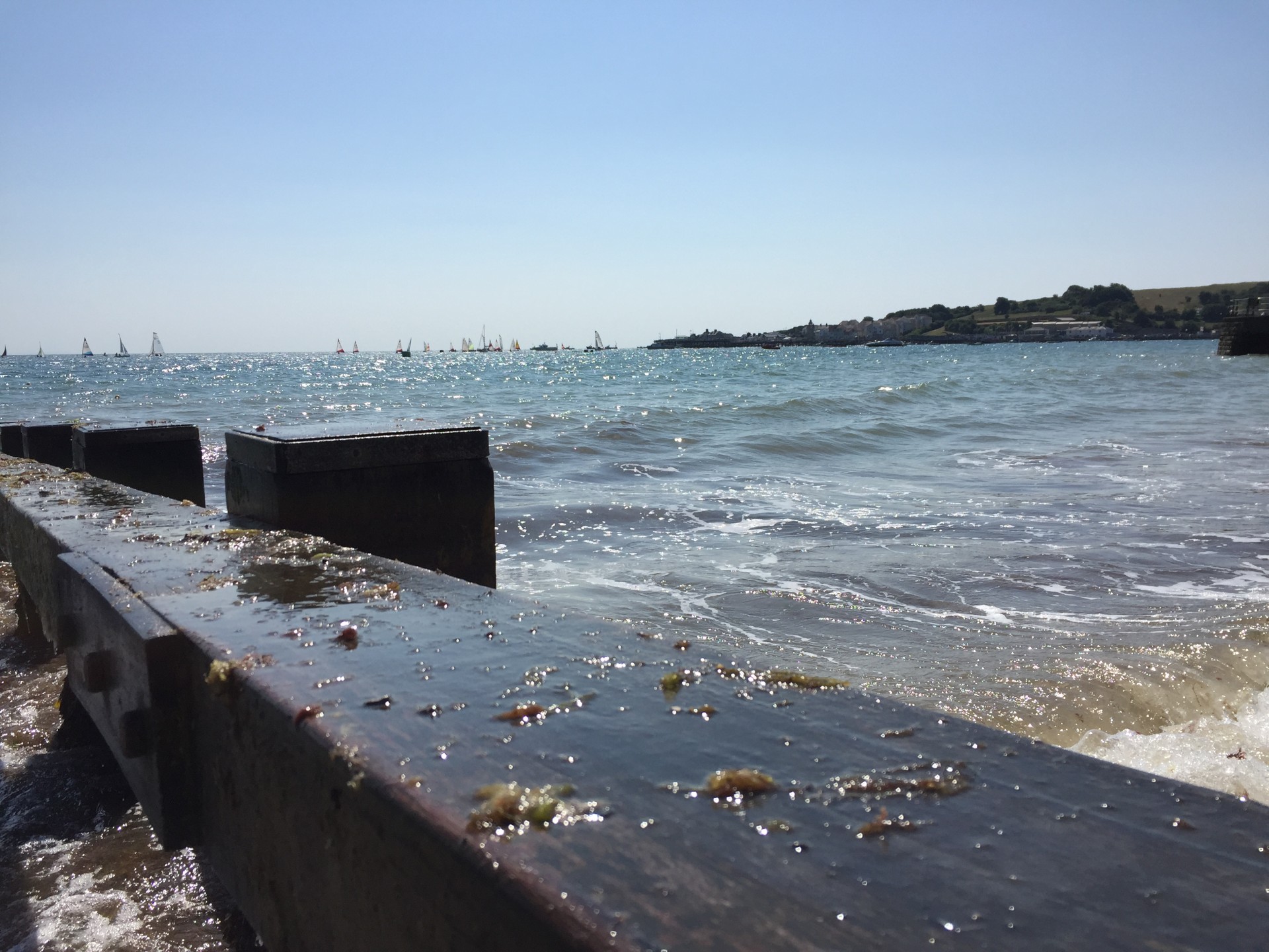 The blue waters of Swanage Bay in the distance with NOMAD Sea Kayaking.