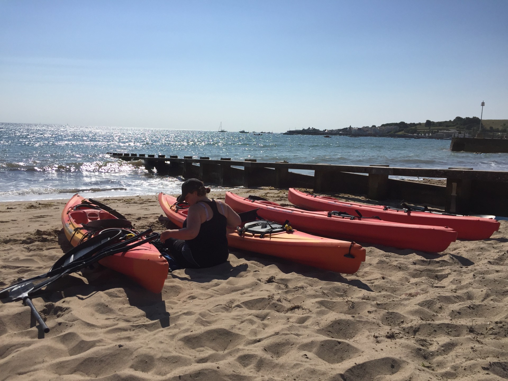 The blue waters of Swanage Bay in the sunshine with NOMAD Sea Kayaking.