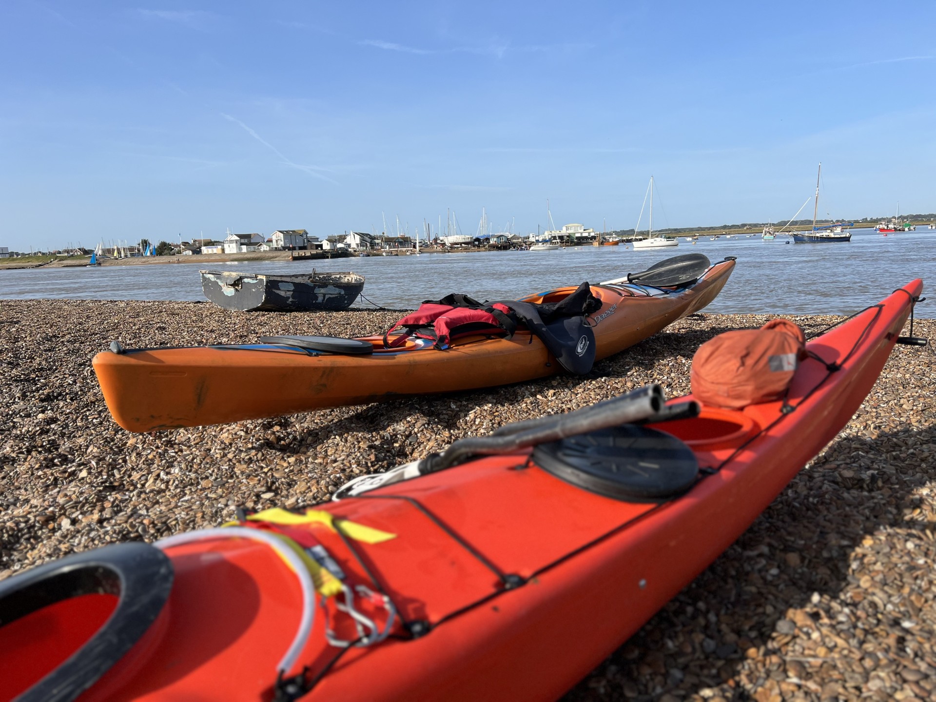 Sea kayaks on the beach with NOMAD Sea Kayaking.