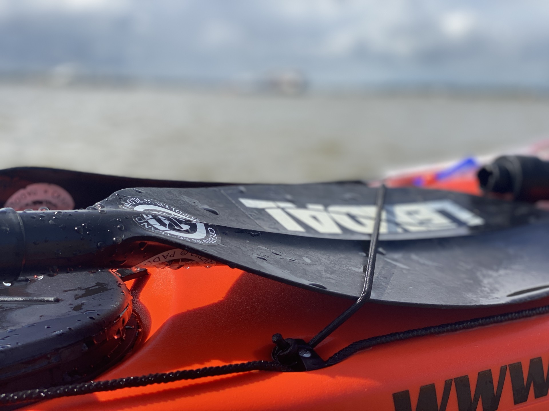 Lendal paddles on a red sea kayak.