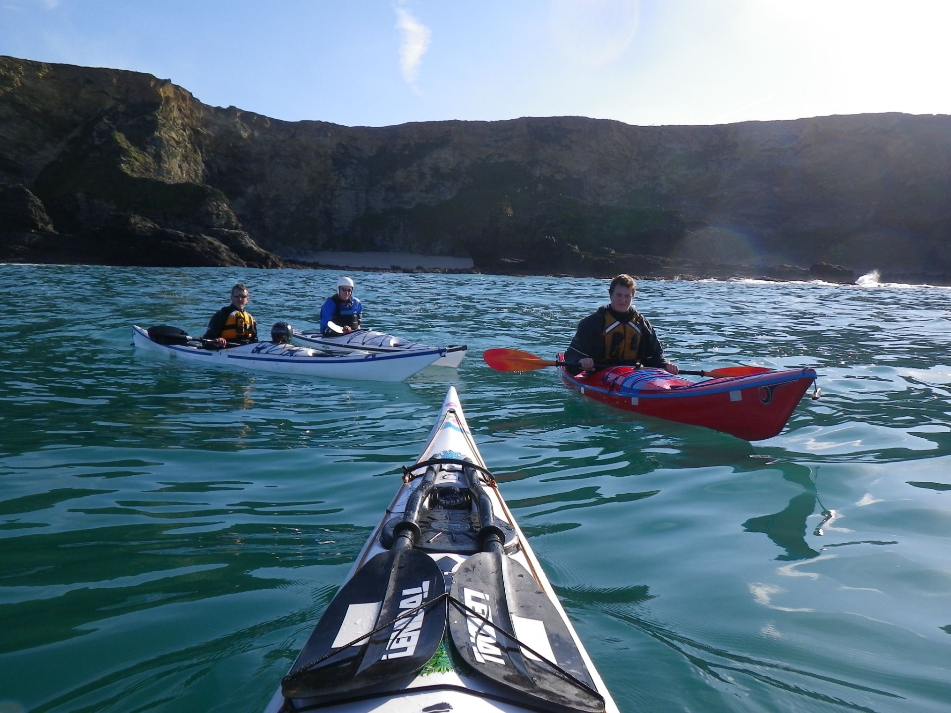 Sea kayakers on the water with NOMAD Sea Kayaking.